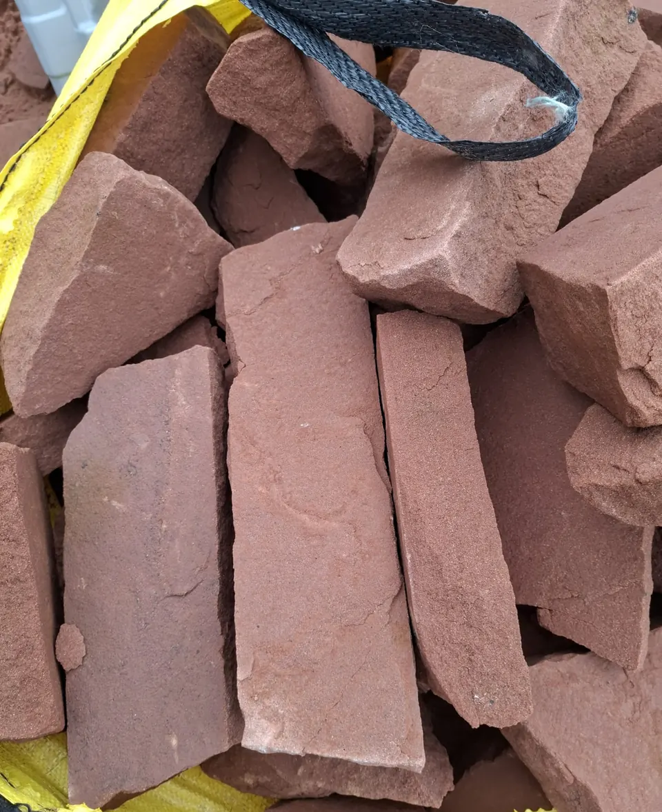 Close-up of random red sandstone walling stone in a bulk bag